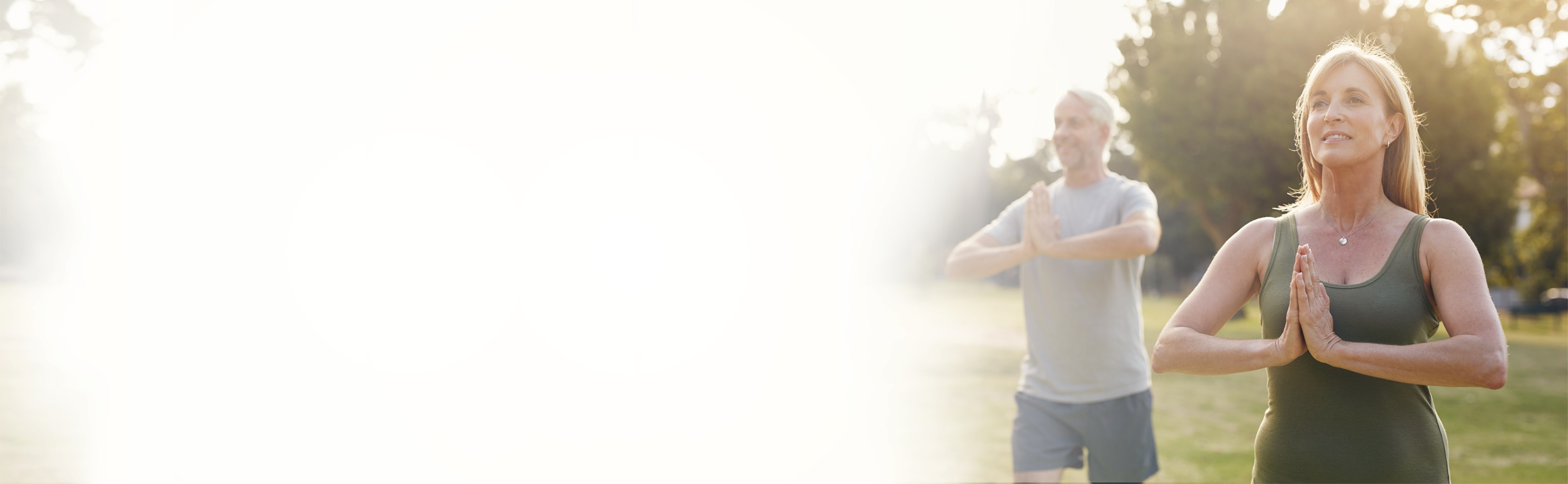 home_header_new_image-2 middle aged couple doing yoga outdoors