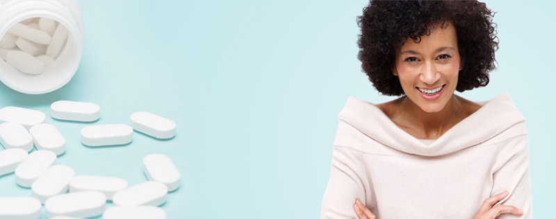 happy middle aged woman on light blue background