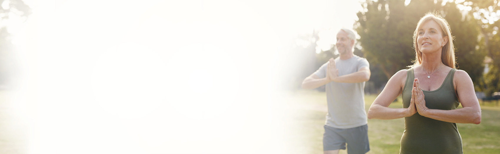 home_header_new_image-2-1 Couple doing yoga outdoors